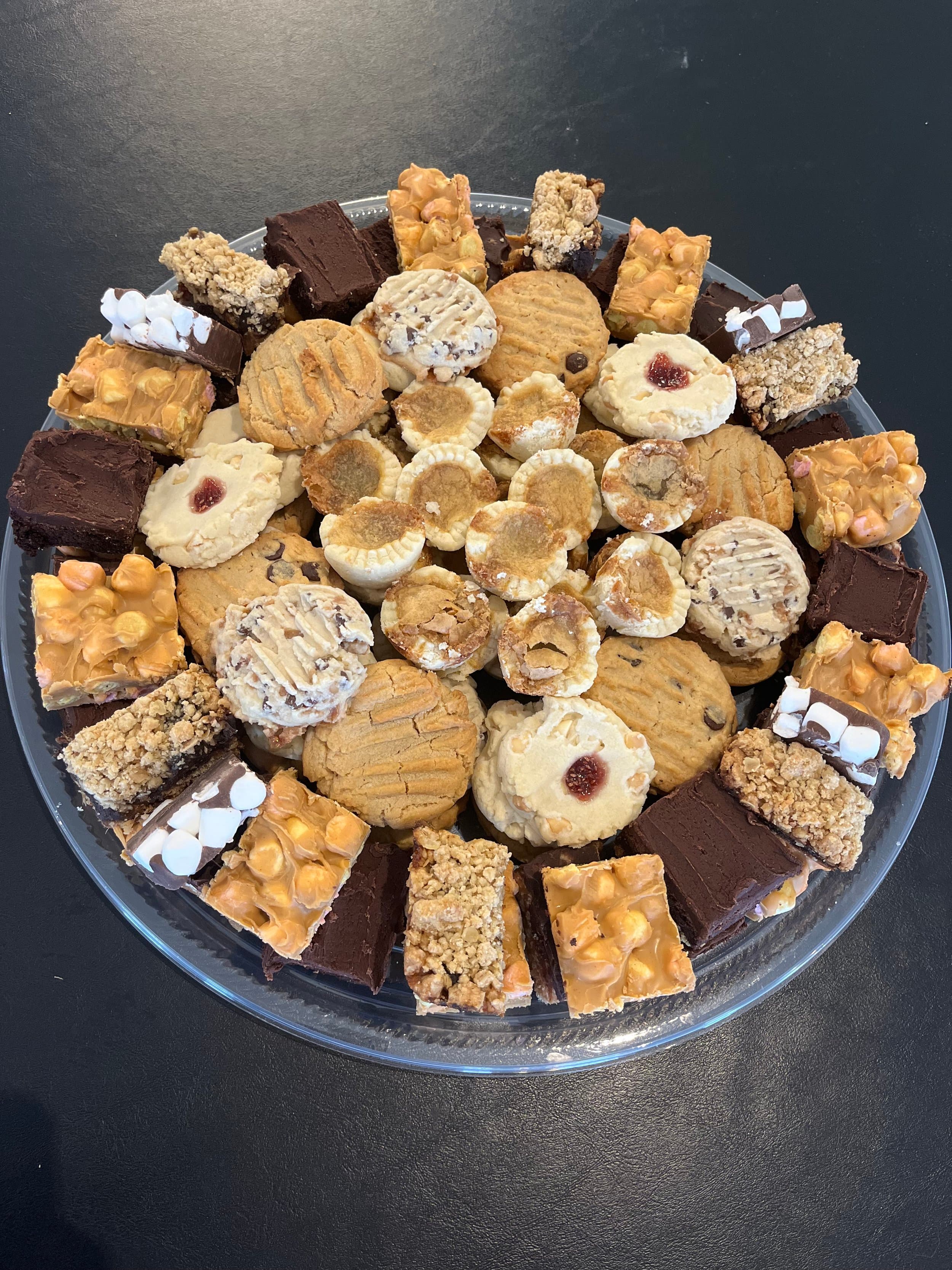 A dessert tray from Robin's Nest Farm Market piled with butter tarts, jam thumbprint cookies, peanut butter cookies, brownies and marshmallow squares